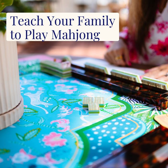 Lara at a mahjong tile table, the Teach Your Family guide cover