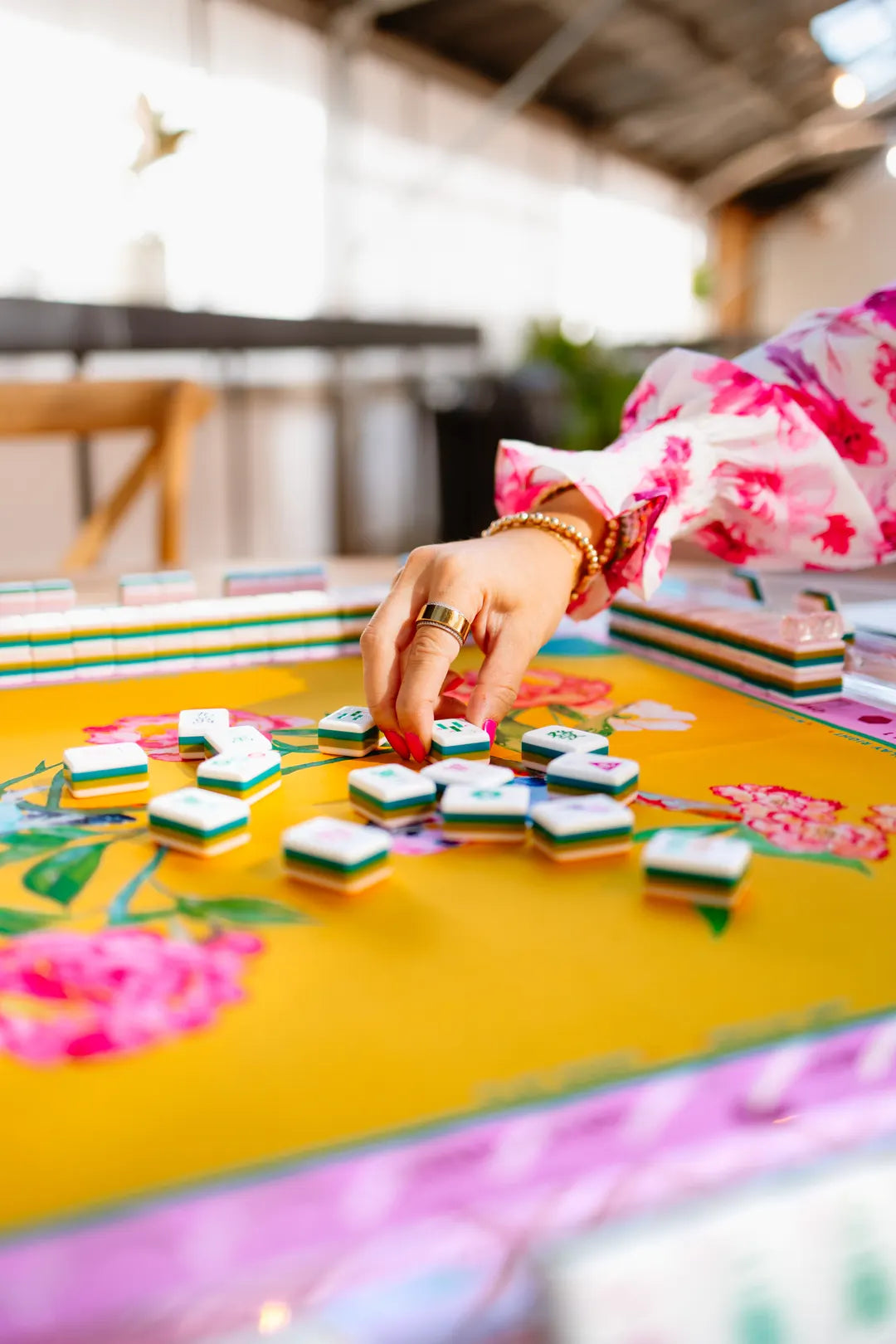 Lara playing American mahjong at a tile table